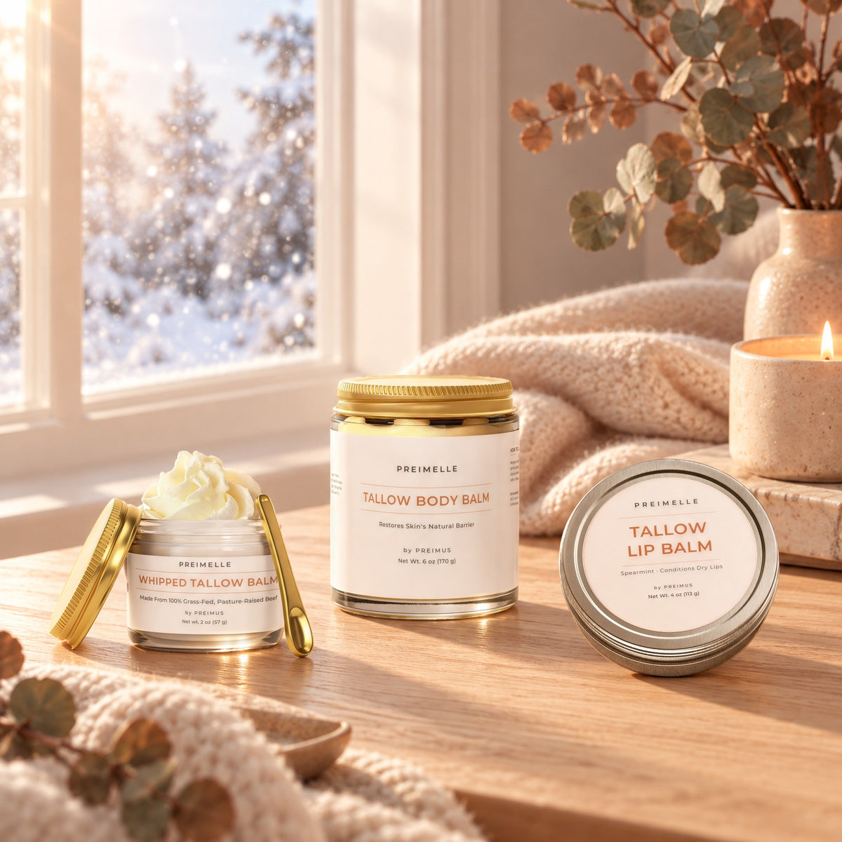 The PREIMELLE Cold Weather Tallow Trio: VALOR, VARIN and VAELO on a table by a snowy window