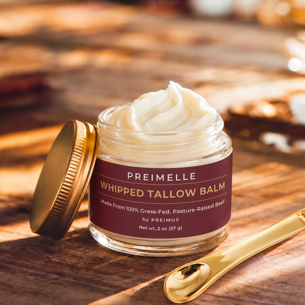PREIMELLE Whipped Tallow Balm with gold spoon on warm wood